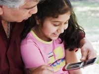 A father teaching his daughter how to use internet on mobile