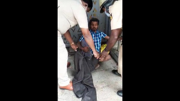 The Assistant Sub-Inspector of Police treating a beggar who is suffering from fever The Assistant Sub-Inspector of Police treating a beggar who is suffering from fever
