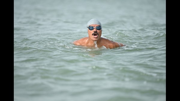 Udupi: 66-year-old Man sets new record for swimming 3.5 km with hands and legs shackled Udupi: 66-year-old Man sets new record for swimming 3.5 km with hands and legs shackled