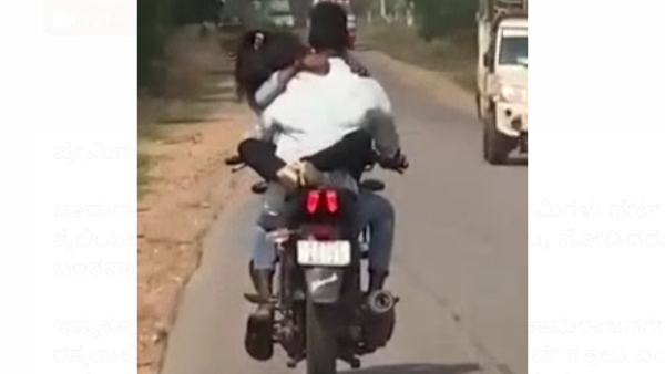 Chamarajanagar: Lovers Romance on Running Bike; Video Goes viral Chamarajanagar: Lovers Romance on Running Bike; Video Goes viral
