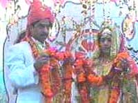 Bride and groom exchanging garlands